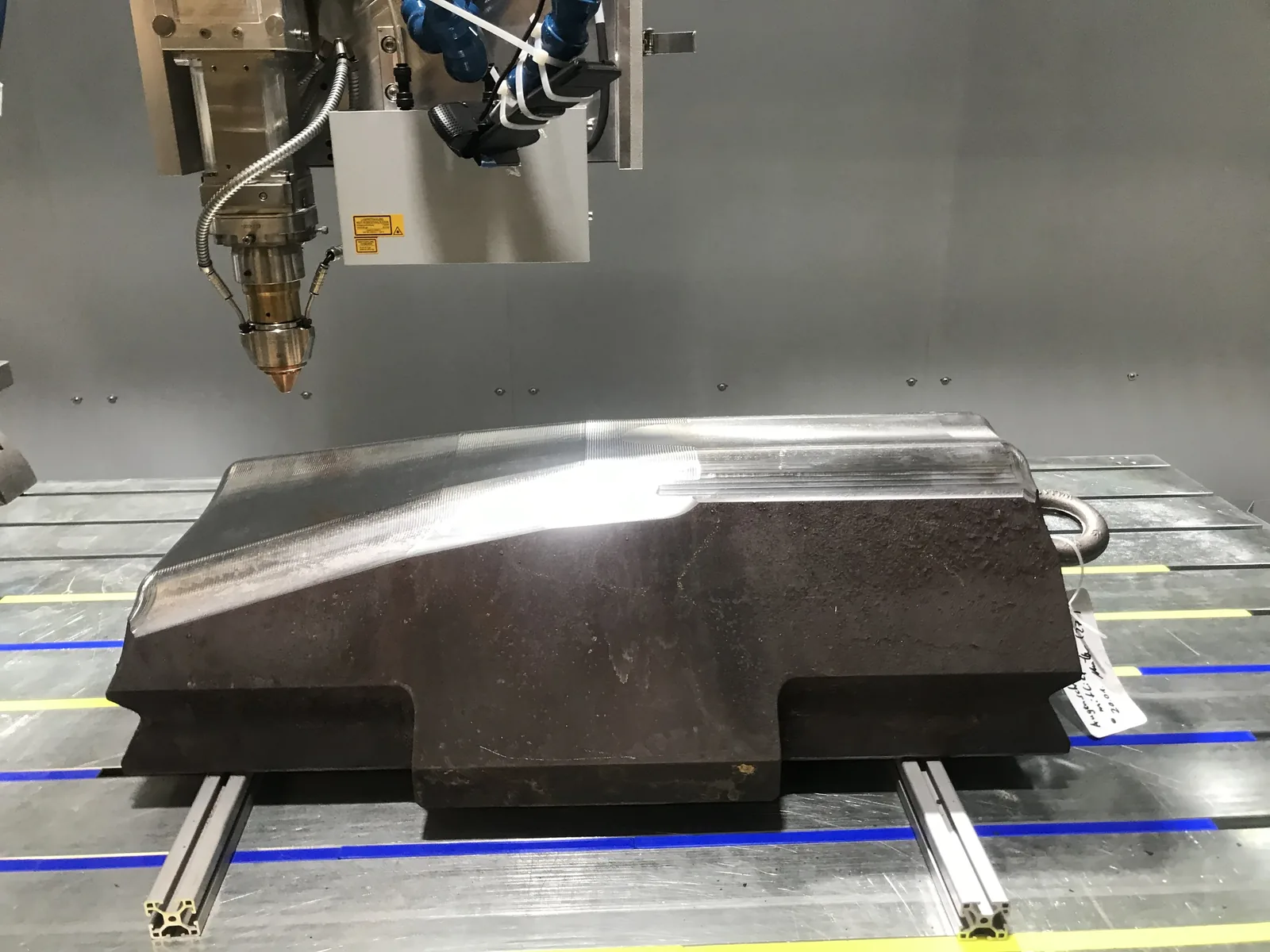 Forging hammer positioned in the LMD machine before deposition